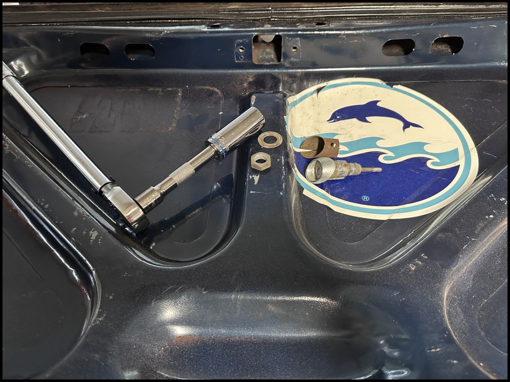 Removed key lock from truck lid prior to paint removal and cleaning.