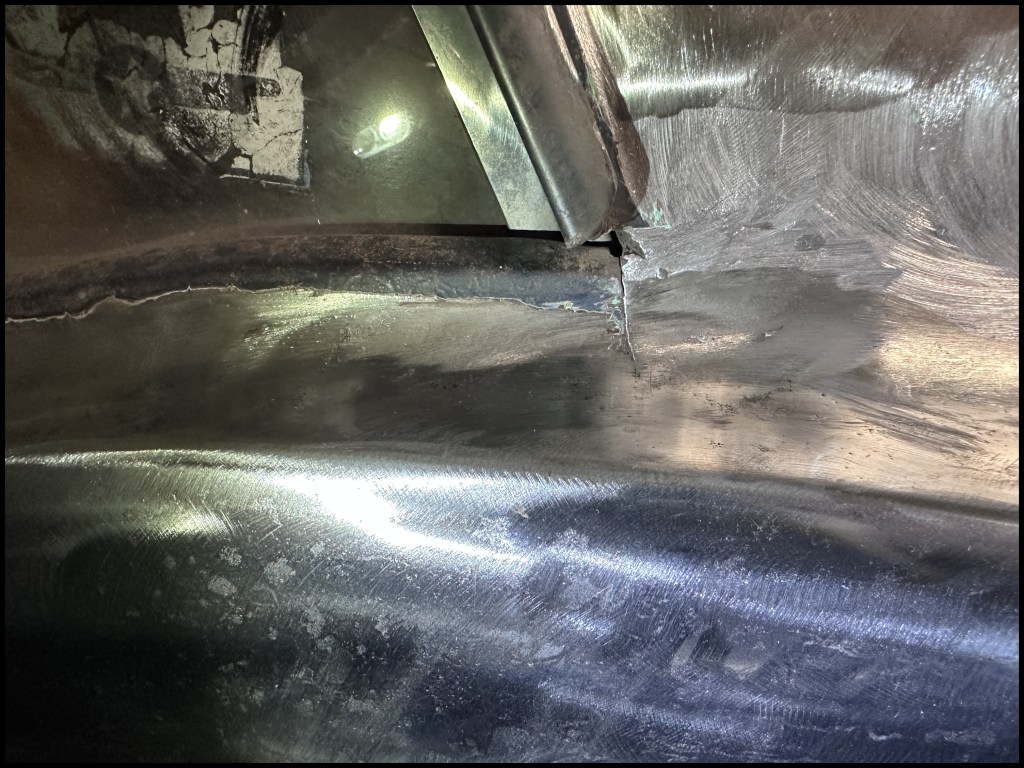 Small crack in the driver-side quarter window/fender line. This needs to be cleaned and welded.