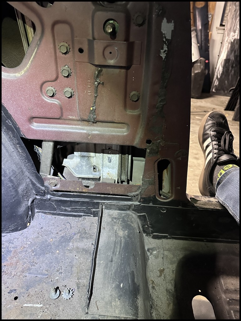 Driver-side quarter window bolt placement.