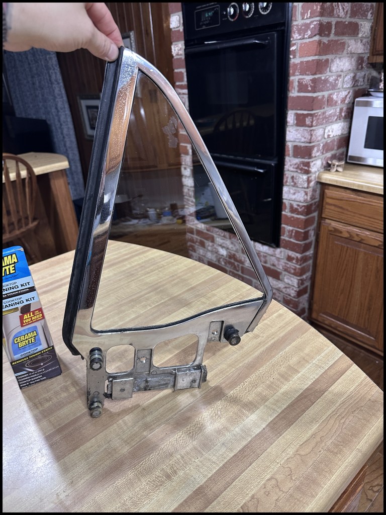 Driver-side quarter window glass and housing after cleaning with Cermabright glass cook surface cleaner.